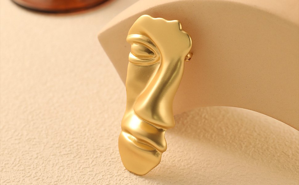 gold mask brooch
